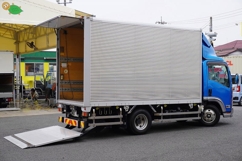 エルフ　「標準幅　セミロング」　アルミバン　積載２８５０ｋｇ　跳ね上げ式　パワーゲート　ラッシング３段　導風板　左電格ミラー　坂道発進補助　社外ナビ　フルセグＴＶ　バックカメラ　ＥＴＣ２．０　フォグランプ　メッキパーツ　日本フルハーフ製　６速ＭＴ！　車検「Ｒ８年３月まで！」フロント画像